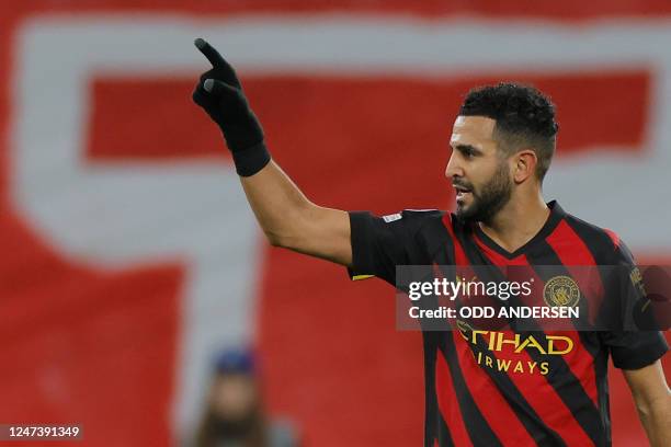 Manchester City's Algerian midfielder Riyad Mahrez celebrates scoring the opening goal during the UEFA Champions League round of 16, first-leg...