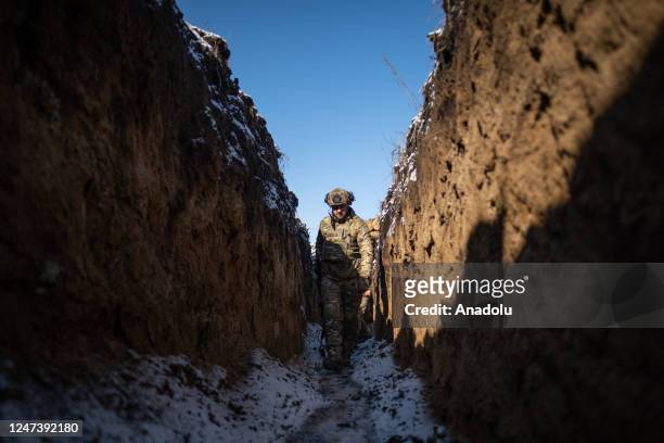 Ukrainian soldier walks through the frozen trenches at the closest observation post to the Russian border on the outskirts of city of Kharkiv,...