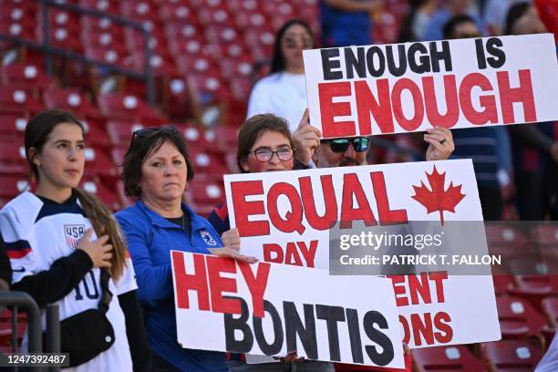 Fans hold signs in support of the Canadian womens national soccer teams protest for equal pay ahead of the 2023 SheBelieves Cup soccer match between...