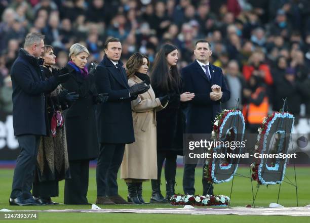 Mark Noble and family members of the Gold family line up for a minutes applause for the late West Ham United chairman David Gold during the Premier...