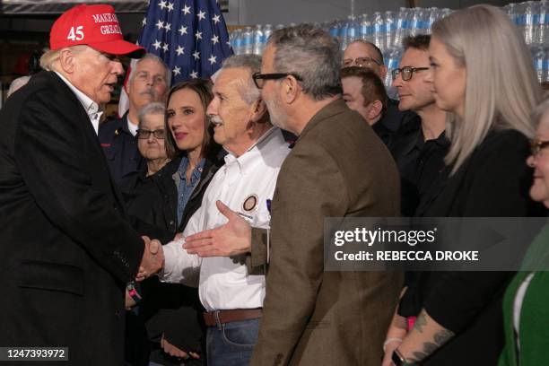 Former US President Donald Trump shakes hands with guests after he spoke at the East Palestine Fire Department in East Palestine, Ohio, on February...