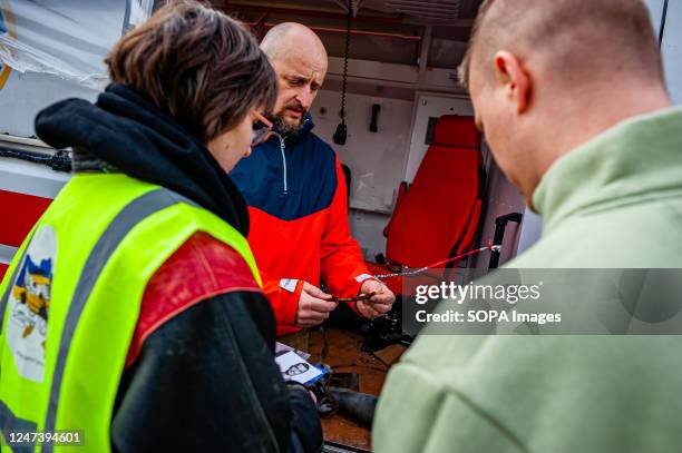 Ukrainian man is seen showing pieces of artillery to a group of people. The Tour De Ambulance is a traveling exhibition featuring an ambulance that...