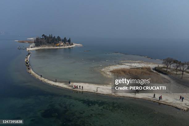 An aerial photo shows the small island of San Biagio, off Manerba del Garda, Lake Garda, on February 21 where the water level dropped to its lowest...