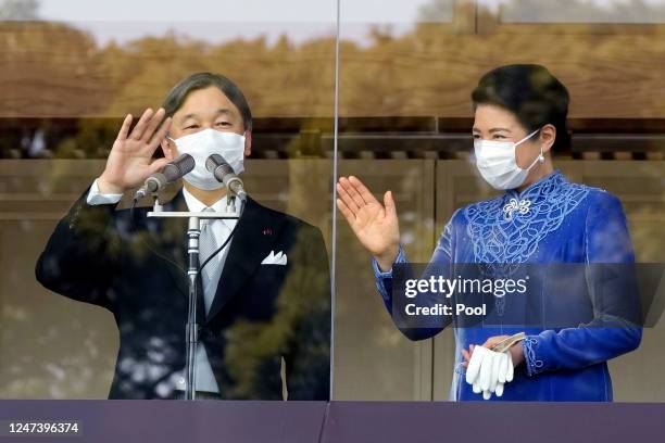 Japan's Emperor Naruhito , accompanied by Empress Masako, waves to well-wishers as he appears on the balcony of the Imperial Palace to mark his 63rd...