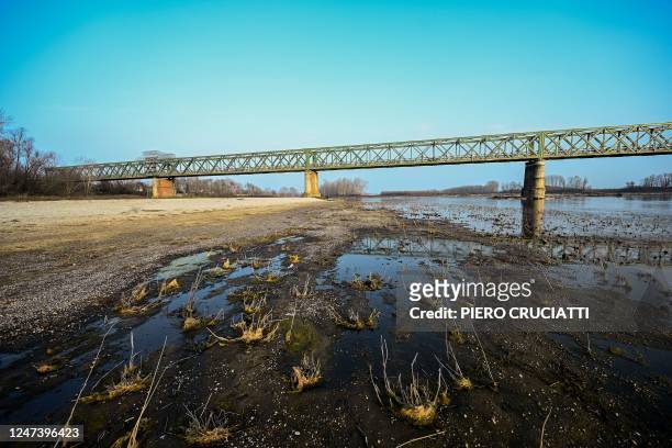 General view shows the almost dry riverbed of the river Po on February 21, 2023 at Ponte della Becca, in Linarolo, near Pavia. - A lack of snow on...