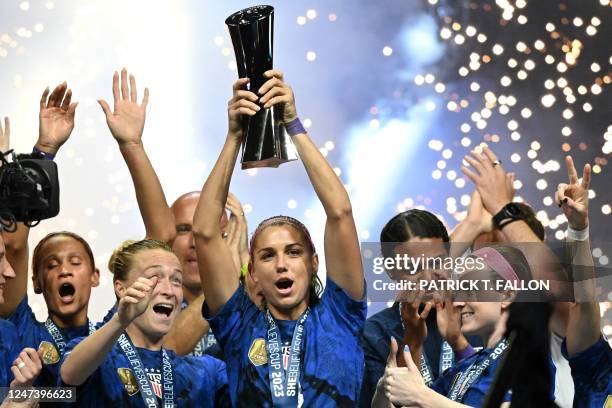 United States forward Alex Morgan raises the SheBelieves Cup trophy as the United States Women's National Soccer Team celebrates following the 2023...