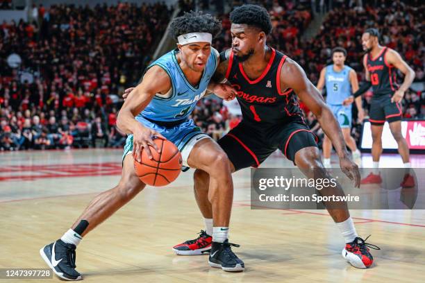 Tulane Green Wave guard Jalen Cook and Houston Cougars guard Jamal Shead collide during the basketball game between the Tulane Green Wave and Houston...