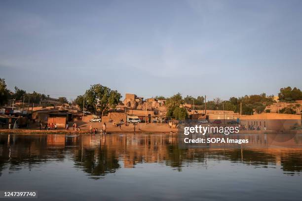 People seen washing clothes at the bank of the Niger River in Niamey. Niger a landlocked West African country of roughly 25 million people - is one...