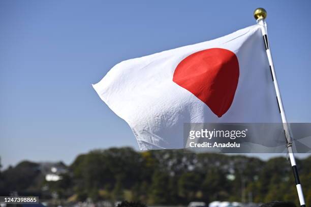 Japanese national flag flutters in the wind as People gather to celebrate Japanese Emperor Naruhitoâs 63rd birthday for a public appearance at the...