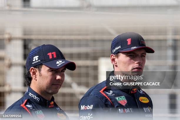 Red Bull Racing's Mexican driver Sergio Perez and Dutch driver Max Verstappen arrive for the first day of Formula One pre-season testing at the...