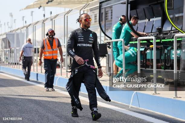 Mercedes' British driver Lewis Hamilton arrives for the first day of Formula One pre-season testing at the Bahrain International Circuit in Sakhir on...