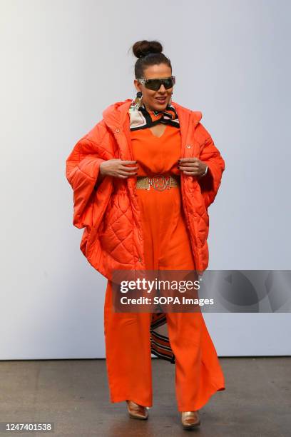 Fashionista wearing orange coloured outfit attends MadByMad show by Mata Durikovic of Slovak Fashion Council at the London Fashion Week, Fashion...