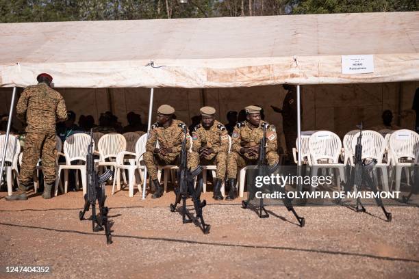 Military officials look on while sitting in Ouagadougou on February 23 ahead of the reburial ceremony of Thomas Sankara's remains alongside his...