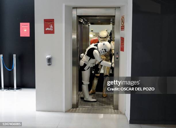 Two people dressed as Star Wars saga's stormtroopers get on a lift on the opening day of the exhibition "Fuenlabrada Friki. Universo Star Wars" in...