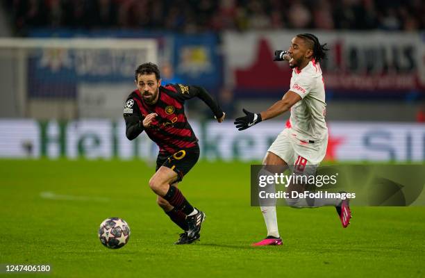 Bernardo Silva of Manchester City and Christopher Nkunku of RB Leipzig battle for the ball during the UEFA Champions League round of 16 leg one match...