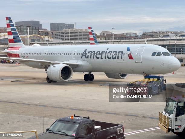 An American Airlines plane sits at the gate at Ronald Reagan Washington National Airport in Arlington, Virginia on february 23, 2023.