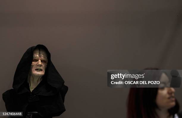 Visitor walks past a bust depicting Star Wars saga's character The Emperor, Sheev Palpatine, on the opening day of the exhibition "Fuenlabrada Friki....