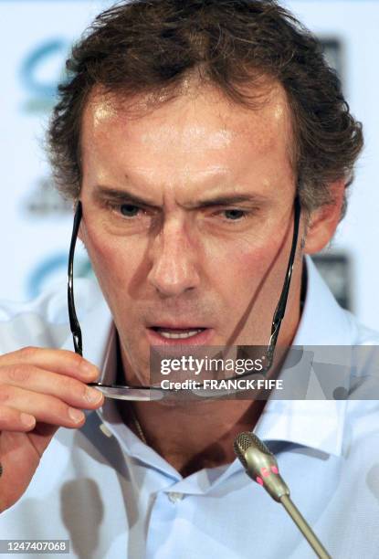 France coach Laurent Blanc puts his glasses on during a press conference on November 10, 2010 in Paris. Laurent Blanc included Barcelona defender...