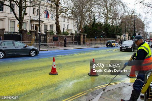 Yellow and blue paint covers the road outside the Russian Embassy to create a giant Ukrainian flag ahead of the one year anniversary of Moscow's...