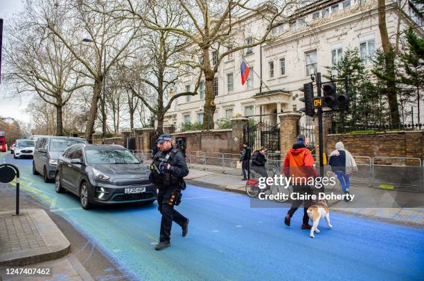 Yellow and blue paint covers the road outside the Russian Embassy to create a giant Ukrainian flag ahead of the one year anniversary of Moscow's...