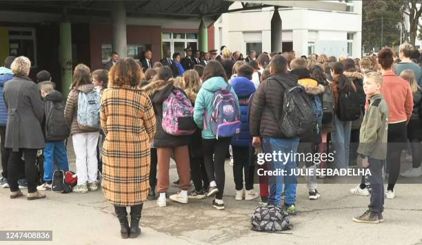 This video grab taken from AFP footage shows French Education and Youth Minister Pap Ndiaye holding a minute of silence with pupils from a middle...