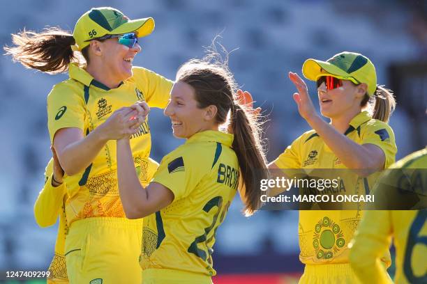 Australia's Darcie Brown celebrates with teammates after the dismissal of India's Richa Ghosh during the semi-final T20 women's World Cup cricket...