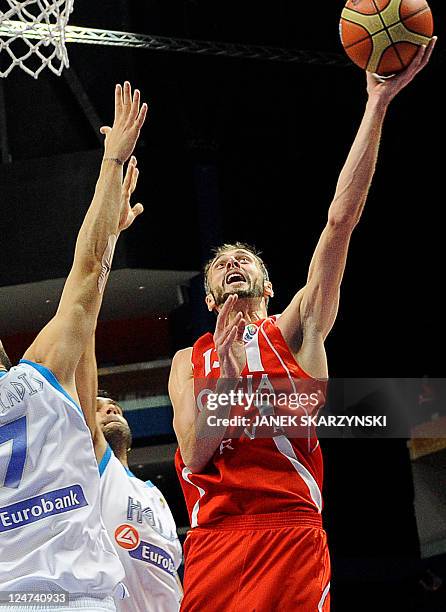 Konstantinos Vasileiadis of Greece vies with Viktor Sanikidze of Georgia during their 2011 European championship second round group F basketball game...