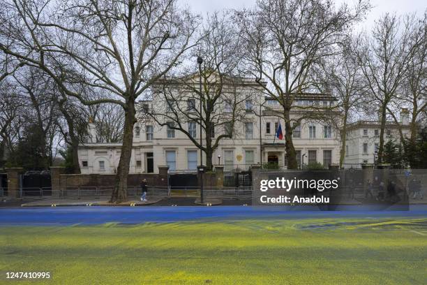 Group of activist paint covers the road outside the Embassy of the Russian Federation to create a Ukrainian flag as the first anniversary of the war...