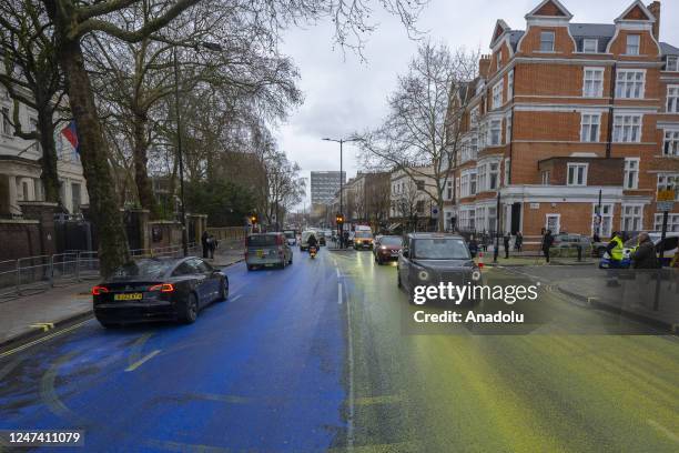 Group of activist paint covers the road outside the Embassy of the Russian Federation to create a Ukrainian flag as the first anniversary of the war...