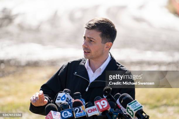 Transportation Secretary Pete Buttigieg delivers remarks to the press as he visited the site of the Norfolk Southern train derailment on February 23,...
