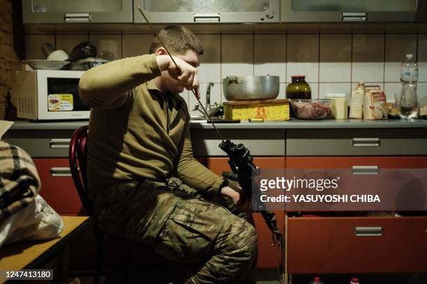 Ukrainian serviceman cleans his M4A1 carbine at a base in the Donetsk region on February 23 amid the Russian invasion of Ukraine.