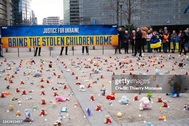People from U.S.-based nonprofit organization avaaz light candles beside teddy bear in Schuman Roundabout, the heart of the EU district on February...