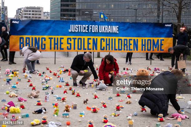 People from U.S.-based nonprofit organization avaaz light candles beside teddy bear in Schuman Roundabout, the heart of the EU district on February...