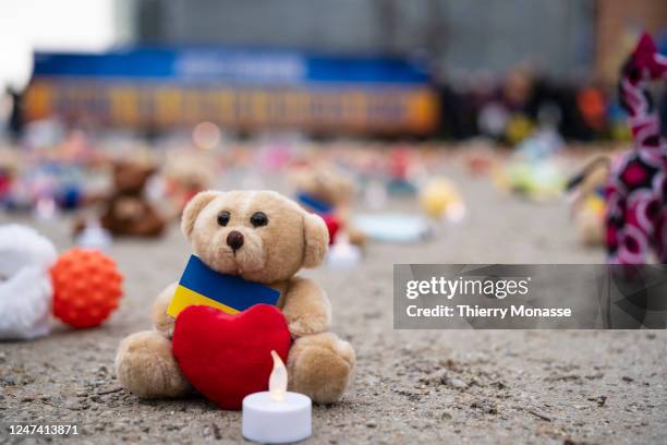 People from U.S.-based nonprofit organization avaaz light candles beside teddy bear in Schuman Roundabout, the heart of the EU district on February...