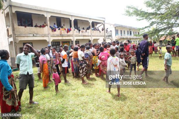 Residents gather in front of the community hall in the aftermath of cyclone Freddy in Mananjary on February 23, 2023. - A powerful cyclone was...