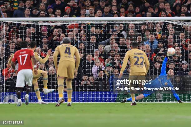 Manchester United goalkeeper David de Gea gets a hand to a penalty from Robert Lewandowski of Barcelona but concedes his side's first goal during the...