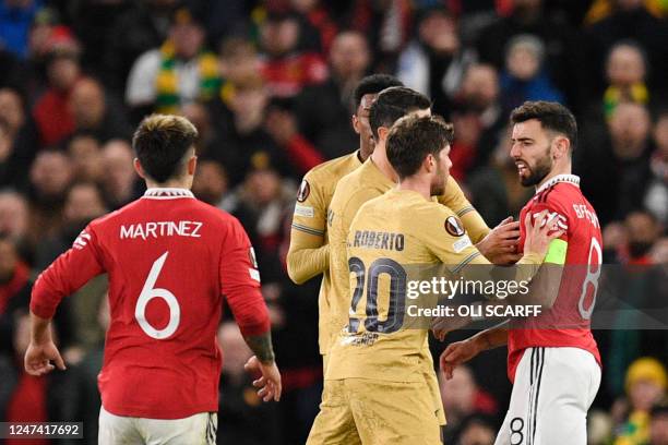 Barcelona's Spanish midfielder Sergi Roberto argues with Manchester United's Portuguese midfielder Bruno Fernandes after he cleared the ball and...