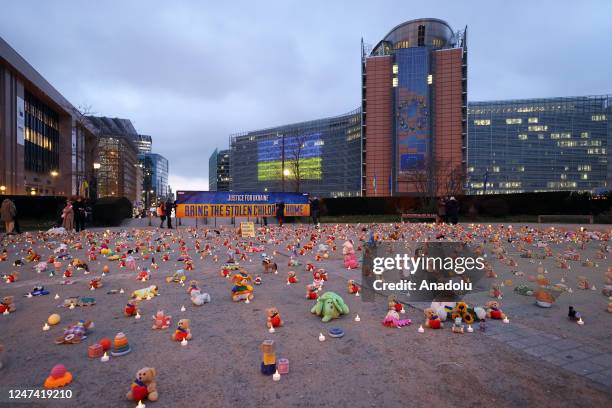 Ukrainians gathered in front of EU Commission building, on the first anniversary of the war, lay candles and toys for the children who lost their...