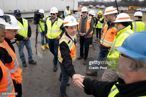 Secretary of Transportation Pete Buttigieg visits with Department of Transportation Investigators at the site of the derailment on February 23 2023...