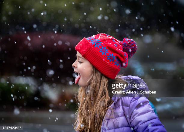 Yukaipa, CA Bailey Griffin of Yucaipa, catches snow on her tongue amidst a rare snow storm in Southern California at Yucaipa Community Park in...