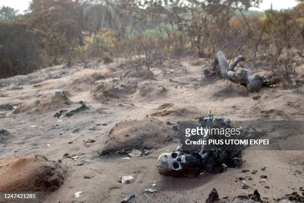 Two burnt bodies lie, 23 June 2003, in eastern Nigerian village of Onicha Amiyi-Uhu, in Abia State. A pipeline carrying petrol through a rural area...