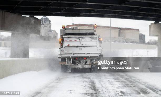 Snow plow clears a highway exit after a winter storm on February 23, 2023 in St. Paul, Minnesota. A winter storm has caused major travel disruption...