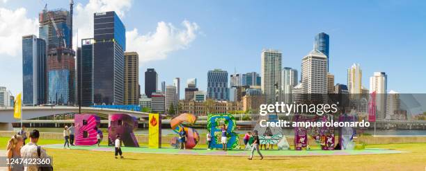 skyline of brisbane with the g20 brisbane sign at south bank, queensland, australia - brisbane stock pictures, royalty-free photos & images