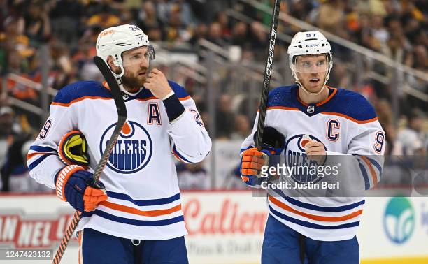 Connor McDavid of the Edmonton Oilers and Leon Draisaitl look on in the first period during the game against the Pittsburgh Penguins at PPG PAINTS...