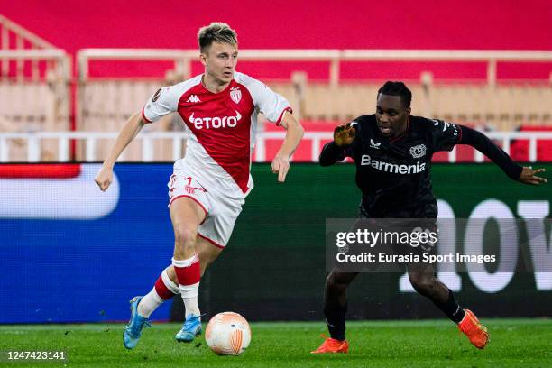 Aleksandr Golovin of Monaco plays against Jeremie Frimpong of Bayer Leverkusen during the UEFA Europa League knockout round play-off leg two match...