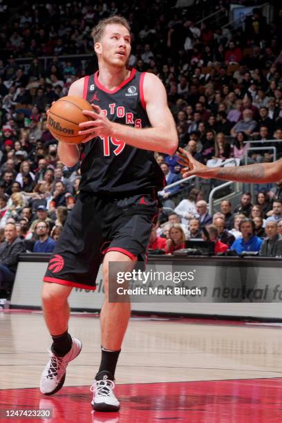 Jakob Poeltl of the Toronto Raptors handles the ball against the New Orleans Pelicans on February 23, 2023 at the Scotiabank Arena in Toronto,...