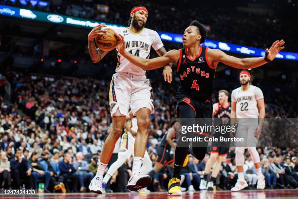 Scottie Barnes of the Toronto Raptors tries to strip a ball from Brandon Ingram of the New Orleans Pelicans during the first half of their NBA game...