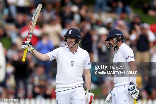 England's Harry Brook celebrates 150 runs with teammate Joe Root during day one of the second cricket Test match between New Zealand and England at...