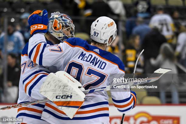 Edmonton Oilers Goalie Stuart Skinner and Edmonton Oilers Center Connor McDavid celebrate a win in the NHL game between the Pittsburgh Penguins and...
