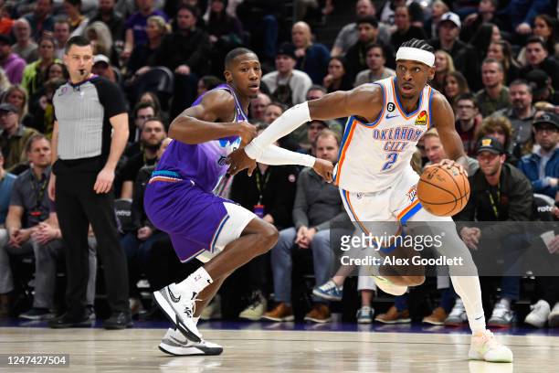 Shai Gilgeous-Alexander of the Oklahoma City Thunder drives past Kris Dunn of the Utah Jazz during the second half of a game at Vivint Arena on...